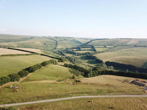an aerial view of a winding road in a field at Rustic rural retreats in Simonsbath