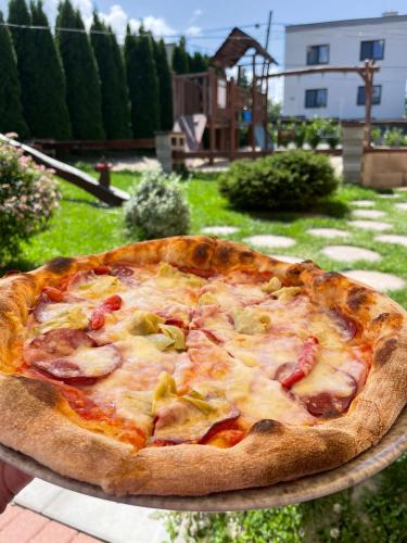 a large pizza sitting on top of a table at Apartmán v Šenku 