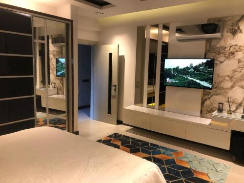 a bedroom with a television on a wall at Villa SONNE in Antalya