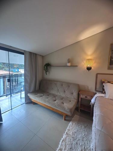 a living room with a couch and a table at Pousada dos Sonhos - MP in Miguel Pereira
