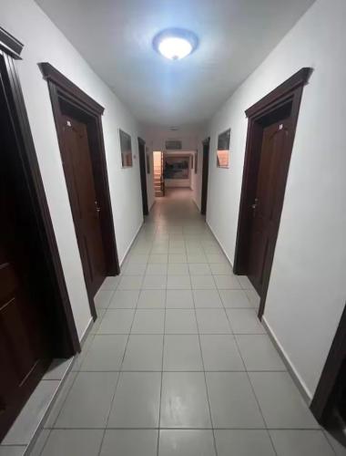 a corridor of a hallway with doors and a tile floor at Onur Motel in Bozdoğan