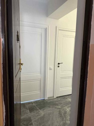 a hallway with two white doors in a room at Clara in Alaverdi
