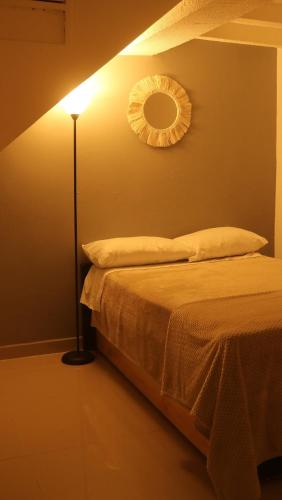 a bedroom with a bed and a mirror on the wall at Casa Bohemia in Circasia