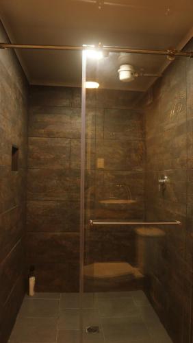 a shower with a glass door in a bathroom at Casa Bohemia in Circasia