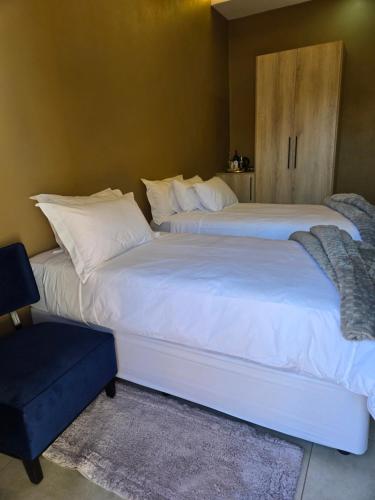 two beds sitting next to each other in a bedroom at Cozy Lifestyle Guesthouse in Naboomspruit