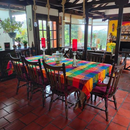 a table with a colorful table cloth on it at Finca Chiala in Subachoque