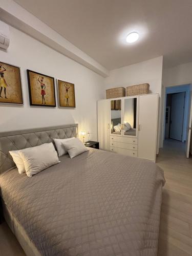 a bedroom with a large bed with two pillows at Stunning Oceanview 2B Waterfront Apartement in Bijilo