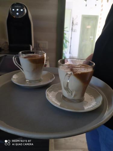two cups of coffee sitting on a table at Beb Diavolo Furbetto in Orco Feglino