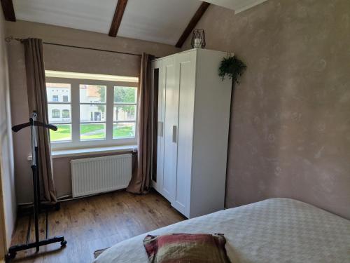 a bedroom with a bed and a window at Jaukus butas senamiestyje in Klaipėda