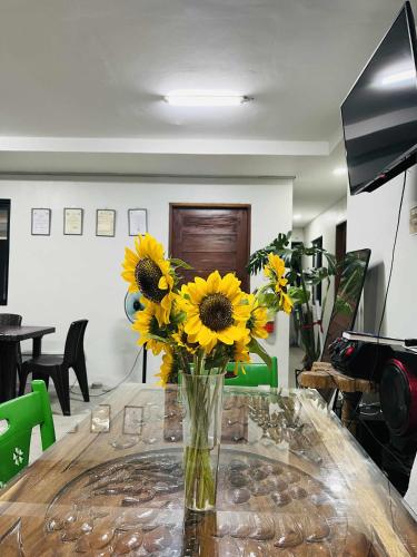 a vase filled with sunflowers sitting on a table at Lisro Sleep and Relax in San Juan