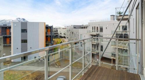 a balcony with a view of a city with buildings at Apartment in Tromsø with parking in Tomasjorda