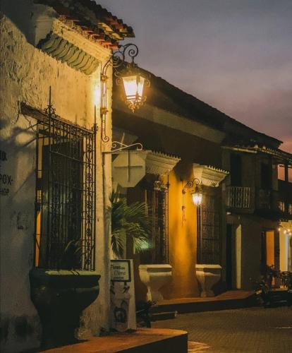 a building with a light on the side of it at El Marquez in Mompos