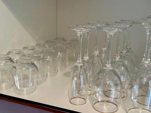 a row of clear wine glasses sitting on a shelf at Ferienhaus am Golfplatz in Stromberg