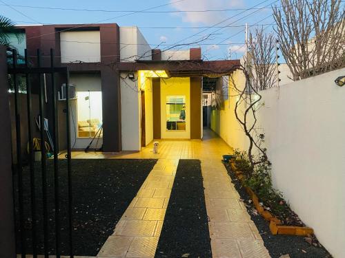 a hallway of a house with a yellow door at Casa Cataratas in Foz do Iguaçu