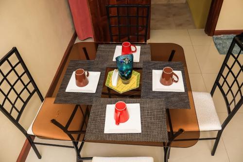 a table with two chairs and a vase on it at Serenity Escape Apt 3 in Runaway Bay