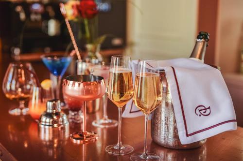 a group of wine glasses sitting on a table at Domaine de Coeurmandie - Hôtel Château in Bény-sur-Mer