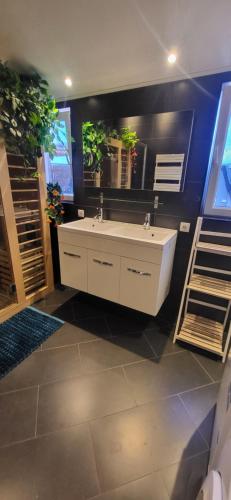 a bathroom with a white tub and a mirror at Slapen bij Ticho in Yerseke