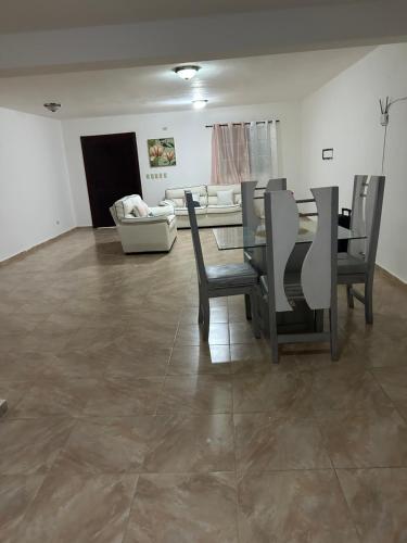 a living room with a table and chairs and a couch at Villas Burnette in Camú