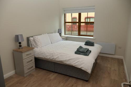 a small bedroom with a bed and a window at 12 Lurganboy Haven 