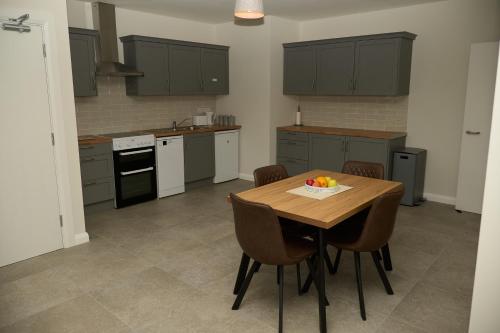 a kitchen with a table with a bowl of fruit on it at 12 Lurganboy Haven 