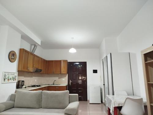 a living room with a couch and a kitchen at SANDY Blue Sea in Durrës
