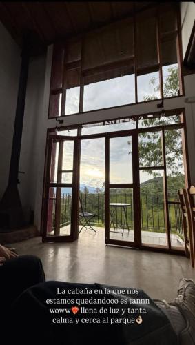 a room with a large glass door with a view at Jardín Utopía in Jardin