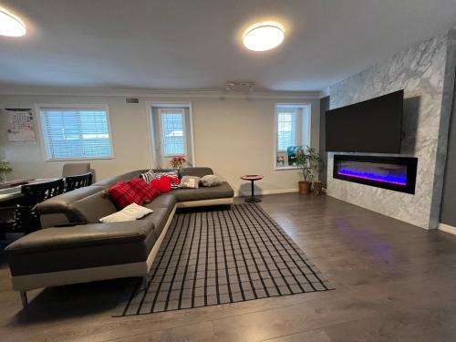 a living room with a couch and a flat screen tv at Vancouver airport 7mins away joy room in Richmond