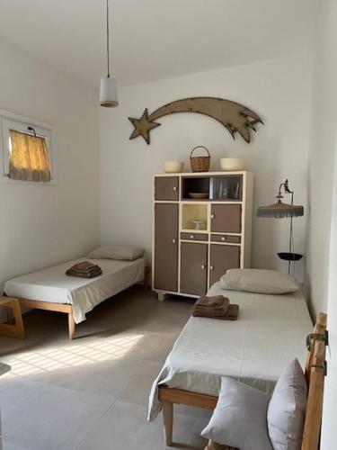 a room with two beds and a shelf with a star at Casa Vacanze La Vecchia Brace in Lequile