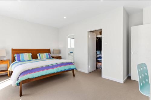 a bedroom with a bed and a closet at Seascape on the Dunes in Sellicks Beach