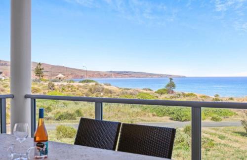 a table with a view of the ocean from a balcony at Seascape on the Dunes in Sellicks Beach