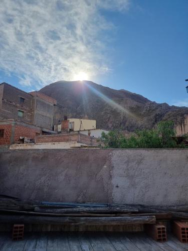 a view of a mountain with the sun shining at Hostal Nahiara, Iruya in Iruya
