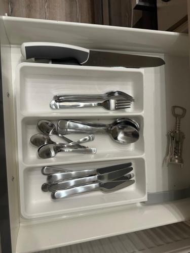 a drawer filled with silver utensils in a refrigerator at Moderne Wohnung im Grünen 