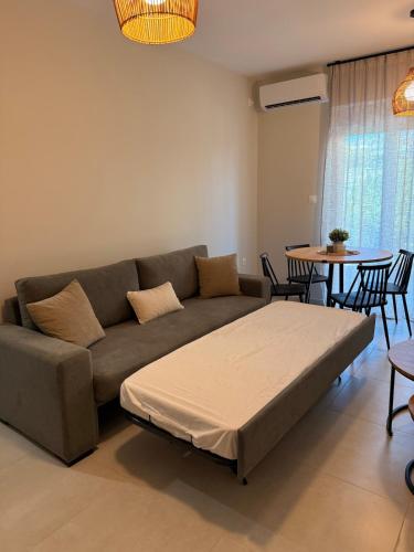 a living room with a couch and a table at Kyveli Apartment in Karistos