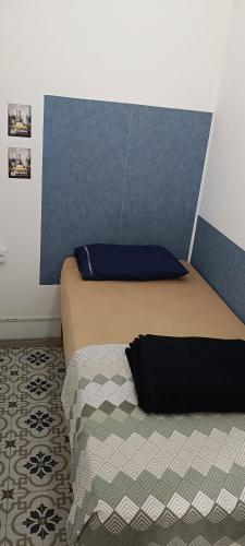 a bedroom with a bed and a pillow on it at Quartos para alugar em Itu Hospedagem Jm 2 in Itu