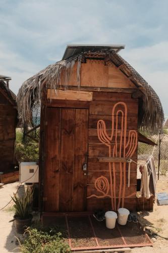 a wooden shack with a cactus painted on it at The Baja Station in San José del Cabo