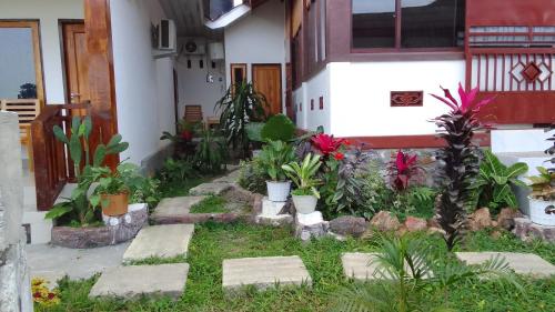 a garden in front of a house with plants at Nan Bungalows Tetebatu in Tetebatu