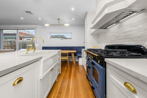 a kitchen with a stove and a sink at Luxury boutique bay retreat in Williamstown