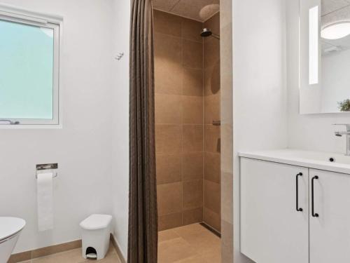 a bathroom with a shower and a toilet and a sink at 5 star holiday home in Otterup in Otterup