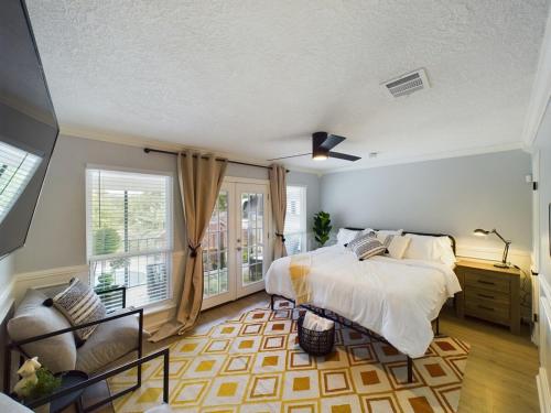 a bedroom with a bed and a chair and a window at Buckle n Boots BNB - 20 minutes to downtown and pool in Houston