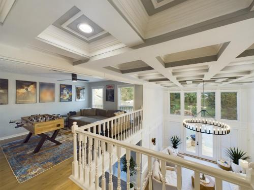 a large living room with white walls and a coffered ceiling at Buckle n Boots BNB - 20 minutes to downtown and pool in Houston