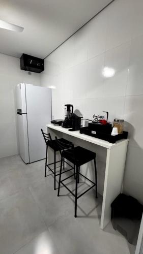 a kitchen with a table with chairs and a refrigerator at Residencial Morales in Cedral