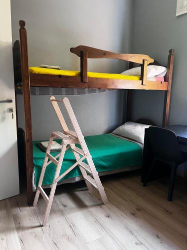 a room with two bunk beds and a chair at Relax, Comfort & Alps Adventures in Chiusa di Pesio