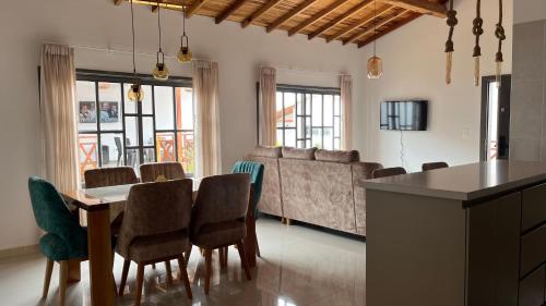 a living room with a table and chairs and a couch at Cabañas Villa Alejandrina in Zapatoca
