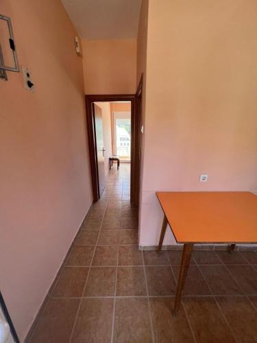 an empty room with a table and a hallway at Makrygialos-Atlantis in Makrýgialos