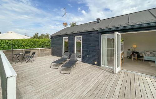 a large deck with chairs and a house at 3 Bedroom Lovely Home In Gedser in Gedser