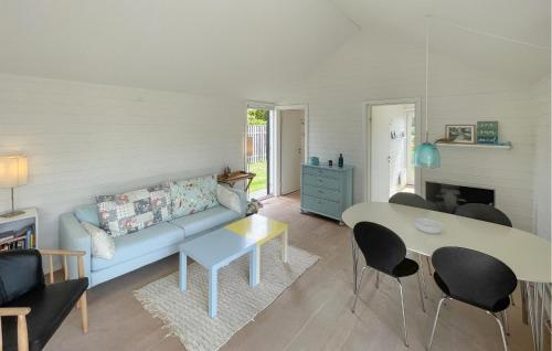 a living room with a blue couch and a table at 3 Bedroom Lovely Home In Gedser in Gedser