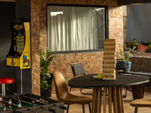 a table and chairs in a living room with a chessboard on it at El Chalet in Vega Baja