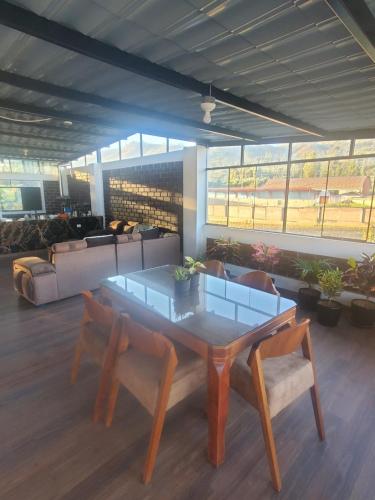 a room with a table and chairs and a couch at Acowasi in Acopampa