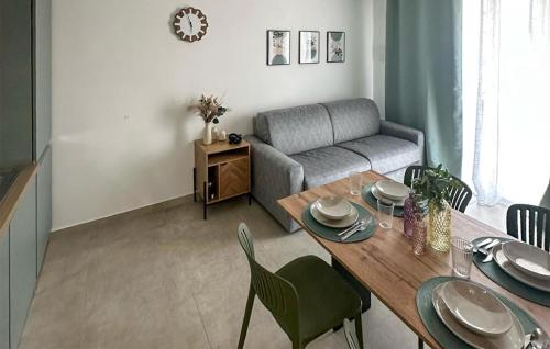 a living room with a table and a couch at Stunning Apartment In Marzamemi in Marzamemi