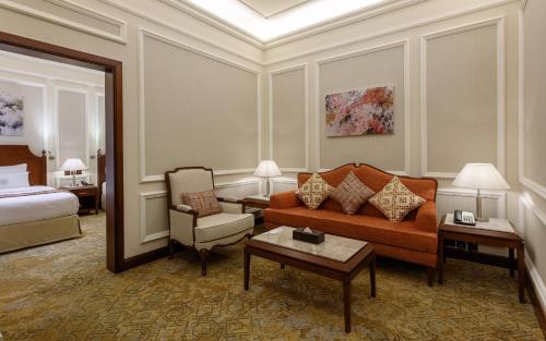a hotel room with a couch and a bed at Sunset Jeddah in Jeddah